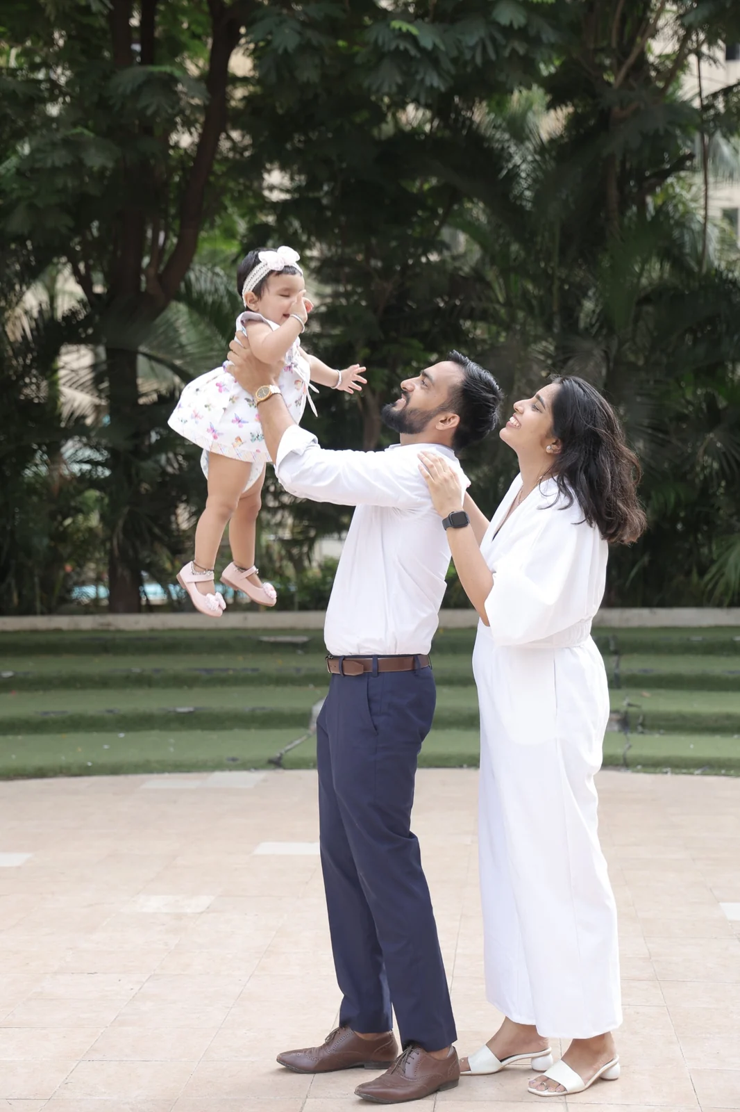 Indian family sharing a joyful moment with their young child